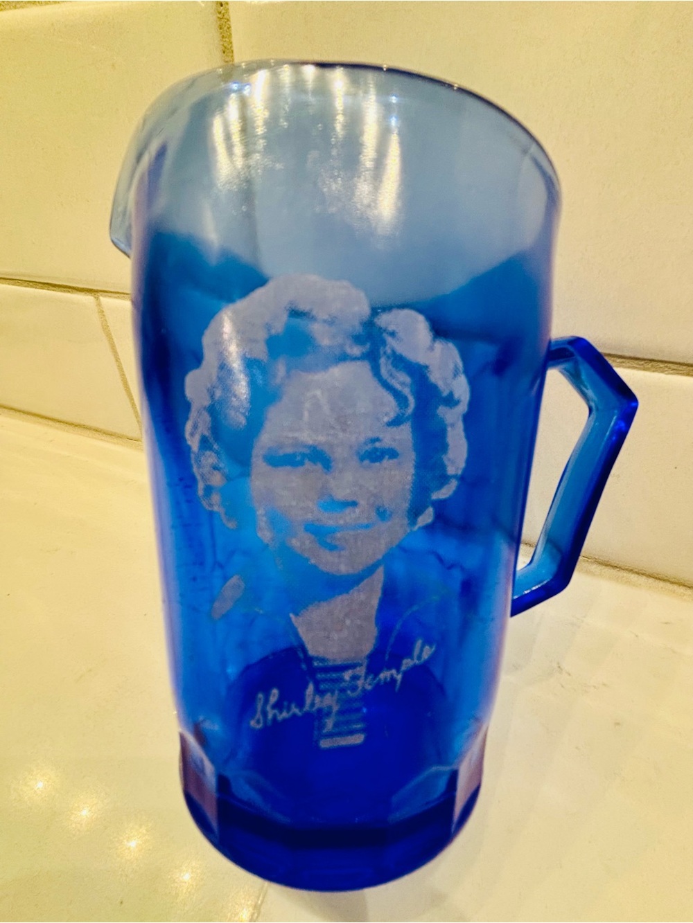 Vintage 1930s Hazel-Atlas cobalt blue glass cup featuring Shirley Temple